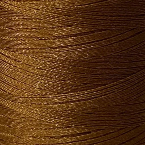 Goudbruin garen op klos in close-up met glanzende textuur